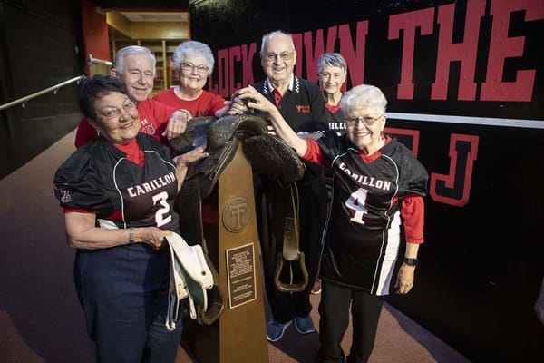 Residents participating in a group activity with a trophy