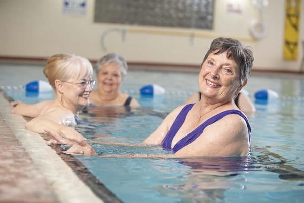 Residents enjoying a water exercise class in the pool