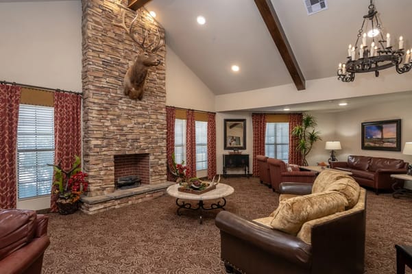 Cozy common area with stone fireplace and seating