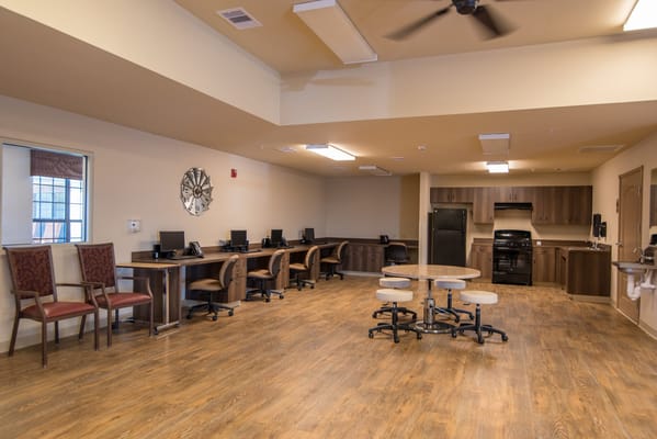 Interior view of a common area with seating and computers
