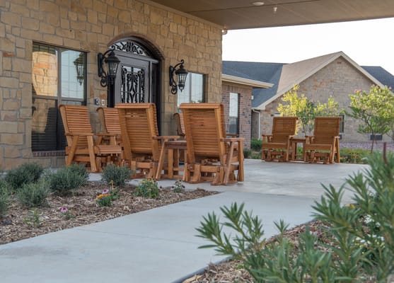 Outdoor seating area with rocking chairs and garden