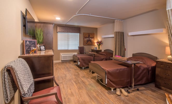 A well-furnished shared bedroom with two adjustable beds