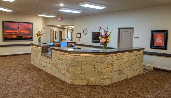 Reception area with stone counter and flowers