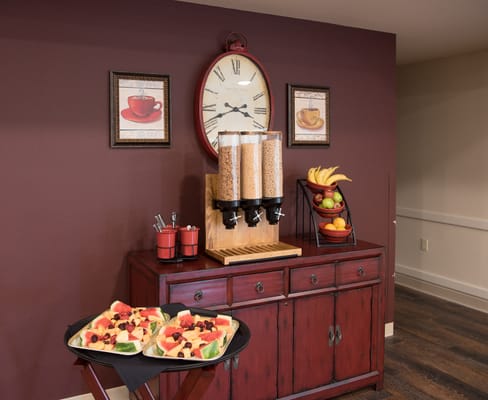 A dining area with fruit and snacks displayed