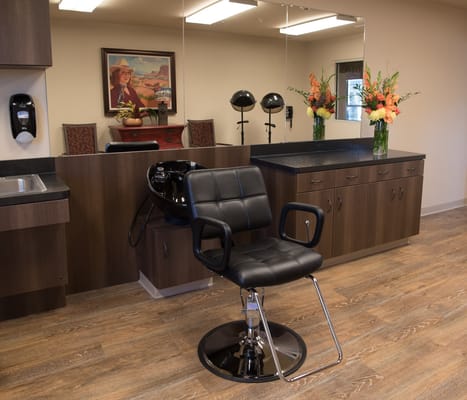 Interior view of a salon area with a styling chair