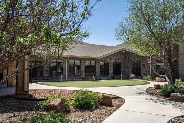 Outdoor space with greenery around the facility building