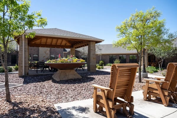 Outdoor seating area with gazebo and flower planters