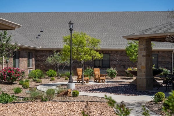 Relaxing outdoor patio area with seating and landscaping
