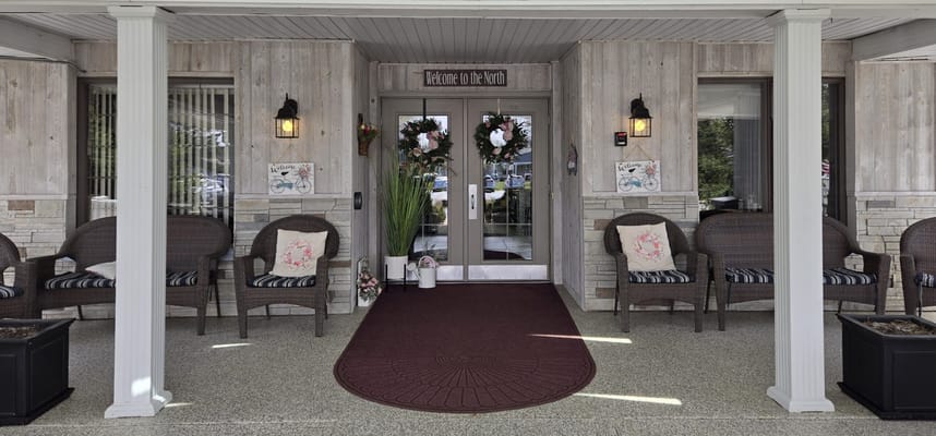 Entrance of Arbor North Living Center with seating area