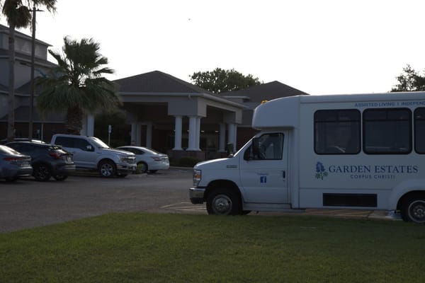 White transportation van parked outside Garden Estates of Corpus Christi