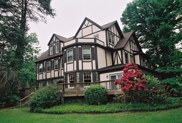Exterior view of a large assisted living facility surrounded by trees and greenery