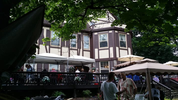 Exterior view of the facility with residents socializing outdoors