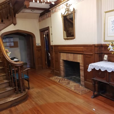 Entrance hallway with wooden staircase and decor
