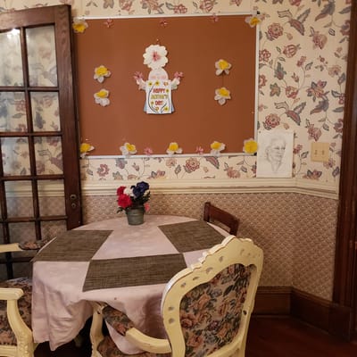 Decorative corner of a room with flowers and artwork