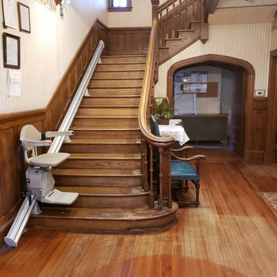 Interior view of a stairway with a chair lift