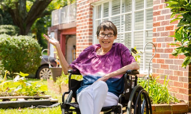 Resident in wheelchair enjoying outdoors