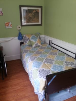 Cozy resident room with a bed and artwork