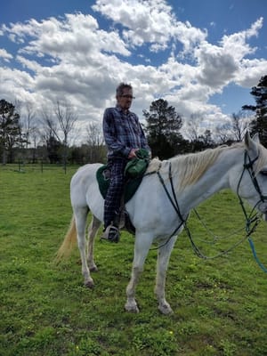 Resident enjoying horseback riding outdoors