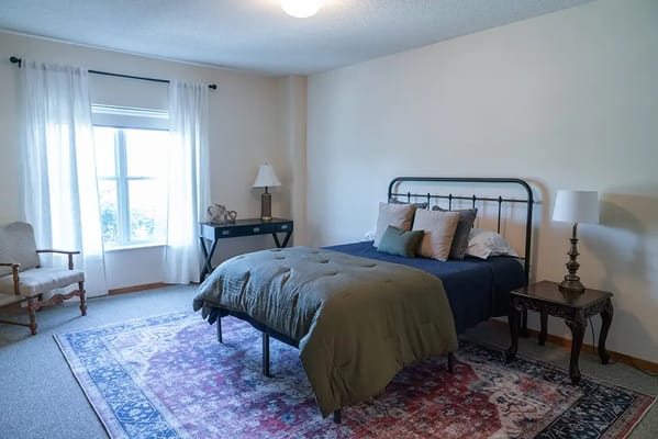 Comfortable private resident room with bed and window