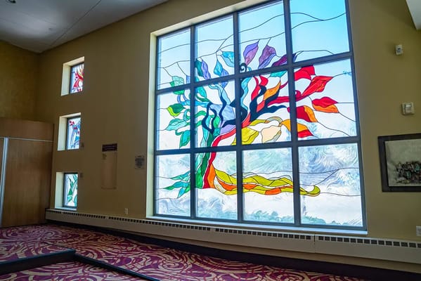Stained glass window featuring a colorful tree design