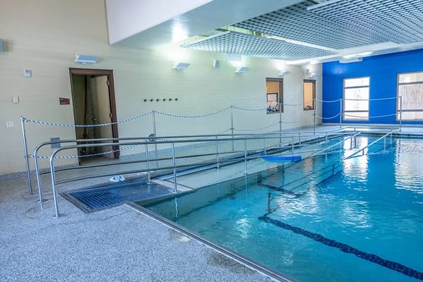 Indoor pool with accessible features and safety railings