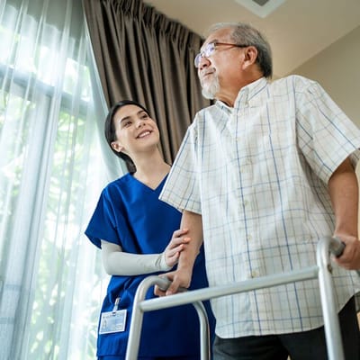 A staff member assisting a resident indoors