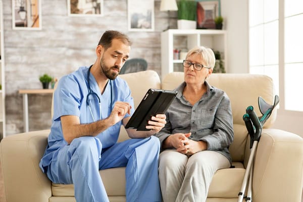 A nurse engaging with a resident in a cozy living area