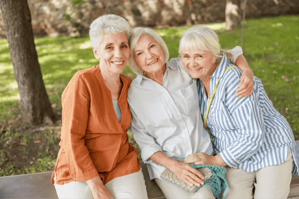 Three smiling senior women enjoying time outdoors