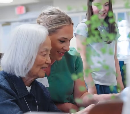 Care staff assisting a resident with a tablet