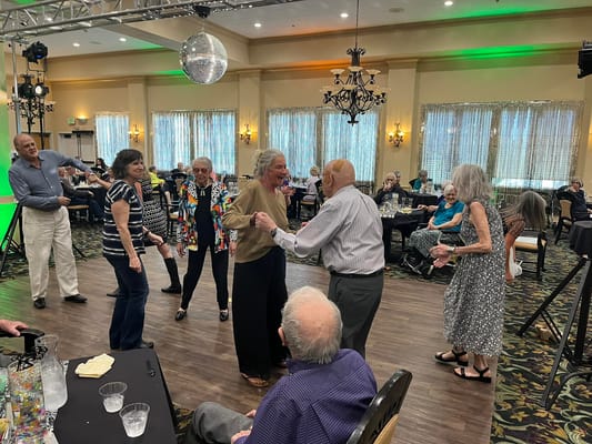 Residents dancing and enjoying a celebration in a common area
