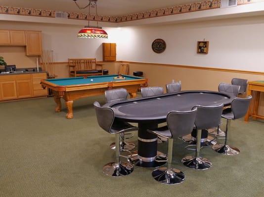 Interior of a recreational room with pool and poker tables