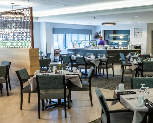 Dining area with well-set tables ready for residents