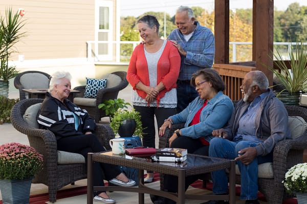 Residents enjoying time together on an outdoor patio