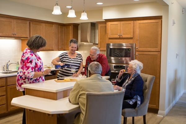 Residents enjoying a social gathering in the kitchen