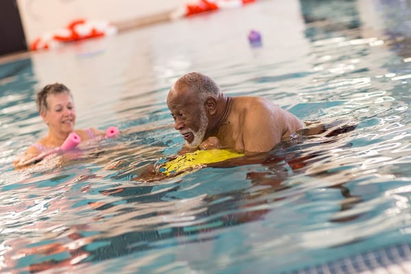 Residents enjoying water activities in the pool