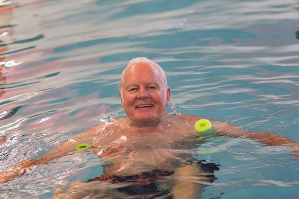 Senior man enjoying therapy in a swimming pool