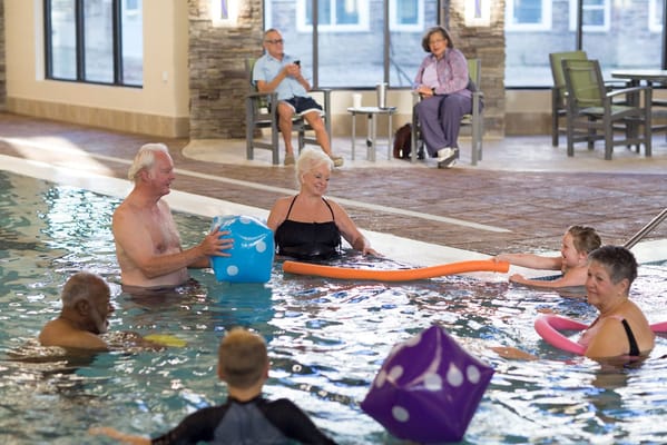 Residents enjoying a fun aquatic activity in the pool