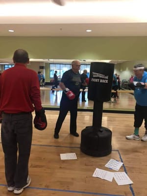 Residents participating in a boxing activity class