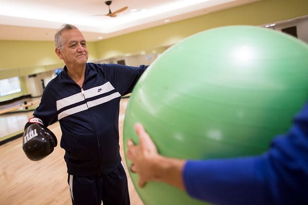 Resident engaging in exercise with a balance ball