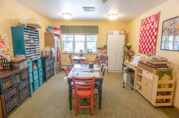 Activity room filled with tables and craft supplies