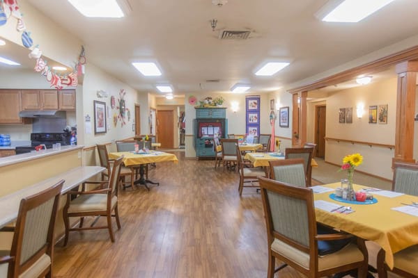 Interior view of a dining room with tables set for meals