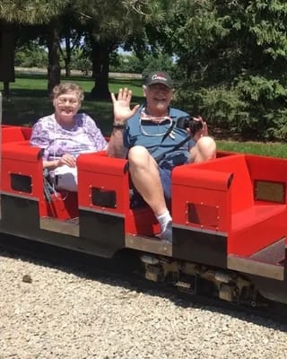 Residents enjoying a ride on a miniature train outdoors