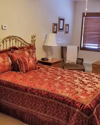 A well-decorated private resident room with ornate bedding