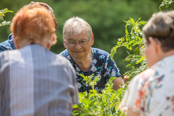 Residents engaging in gardening activity outdoors