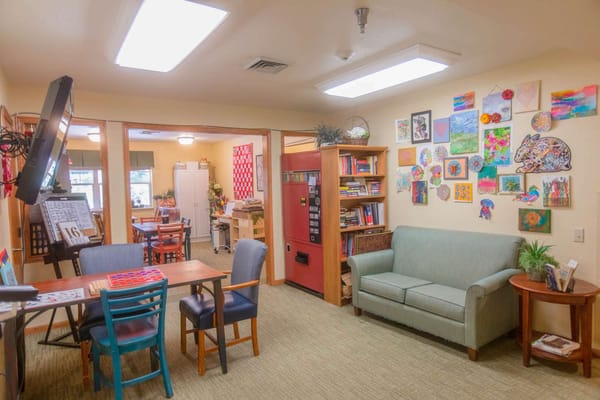 Cozy activity room with art decorations and seating