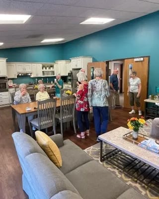 Residents and staff interacting in a common area lounge