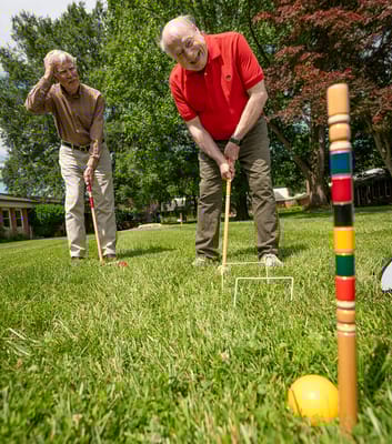 Residents playing croquet on the grass