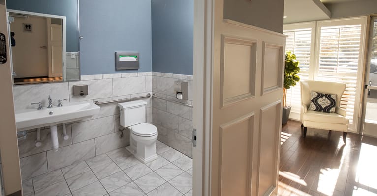 Bright bathroom with modern fixtures and seating area