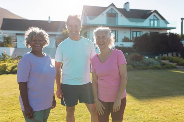 Three residents enjoying a sunny outdoor space