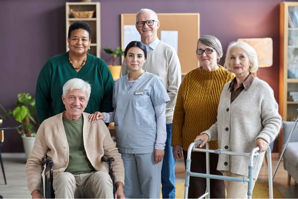 Residents and staff posing together in a common area